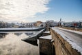 Gothic medieval Stony Deer bridge with show Riverbank of the Otava river in winter sunny day the oldest bridge in historical