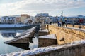 Gothic medieval Stony Deer bridge with show Riverbank of the Otava river in winter sunny day the oldest bridge in historical