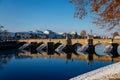 Gothic medieval Stony Deer bridge with show Riverbank of the Otava river in winter sunny day the oldest bridge in historical