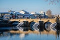 Gothic medieval Stony Deer bridge with show Riverbank of the Otava river in winter sunny day the oldest bridge in historical