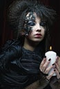 Gothic portrait of woman with candle.