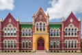 gothic revival school building with colorful pointed arch windows