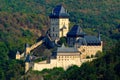 Gothic royal castle Karlstejn in green forest during autumn, Central Bohemia, Czech republic, Europe. State caste in the forest. Royalty Free Stock Photo