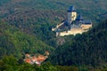 Gothic royal castle Karlstejn in green forest during autumn, Central Bohemia, Czech republic, Europe. State caste in with village