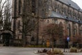 Gothic stone church of the Nativity of the Virgin Mary in winter day, cityscape of medieval town with historical buildings,