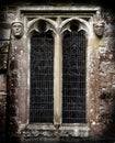 Gothic Stone Faces next to a church window