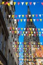 Tower of the Lambertikirche and gabled houses with spanned pennants in the city colors on Prinzipalmarkt in Muenster, Westphalia