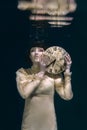 Gothic woman with clock in her hands in black veil underwater Royalty Free Stock Photo