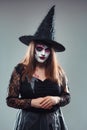 Gothic young woman in witch halloween costume with hat standing Royalty Free Stock Photo