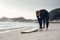 Gotta make sure its strapped to my ankle. a young man out surfing at the beach.