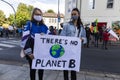 Two Young Women Holding Up Sign Against Climate Change