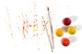 Gouache jars and paint brushes on a white background with colorful spray in top view Royalty Free Stock Photo