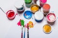 Gouache paint, brushes, and colored pencils on a light background Royalty Free Stock Photo