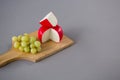 Gouda cheese with grapes on chopping board Royalty Free Stock Photo