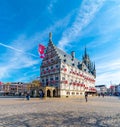 Gouda, Netherlands - 14.4.2022: Gouda main square and town hall. Blue sky, spring weather