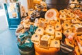 Gouda, Netherlands - July 20, 2020: many different kinds large delicious hunks of cheese on the shelves on sale in a Cheese shop Royalty Free Stock Photo