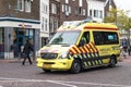 Yellow emergency health care ambulance on an urban city street