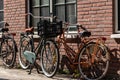 Gouda, South Holland/the Netherlands - April 27 2020: Couple of bikes parked in front of a house in bright sunlight Royalty Free Stock Photo