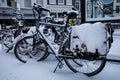 Gouda, South Holland/The Netherlands - February 7 2021: Outside parked bicycles covered with snow and ice in the city center of