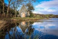 Gougane Barra, County Cork, Ireland, where water flows gracefully around a historic chapel