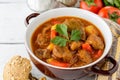 Goulash in ceramic bowl on white wooden background. Traditional hungarian soup. Royalty Free Stock Photo