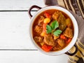 Goulash in ceramic bowl on white wooden background. Traditional hungarian soup. Royalty Free Stock Photo