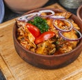 goulash from chicken pieces and vegetables, served with greens, red pepper and onion rings according Royalty Free Stock Photo