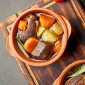 Goulash with large pieces of beef and vegetables. Burgundy meat. Close up. Top view Royalty Free Stock Photo