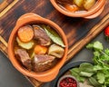Goulash with large pieces of beef and vegetables. Burgundy meat. Slow stewing, cooking in two pot Royalty Free Stock Photo