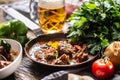 Goulash served in a pan with a fresh tap beer in the background Royalty Free Stock Photo