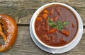 Goulash soup and pretzel at beer garden, traditional Bavarian food