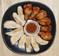 Goup of slice of healthy grilled fresh chicken breast and fried chicken legs serving with spicy sauce on Black ceramic plate Royalty Free Stock Photo