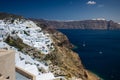 Gourgeous view from white walled town of Oia in Santorini, Greece, with ocean, cliffs and caldera of Santorini in the