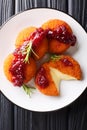 Gourmet appetizer Camembert in breading served with cranberry sauce and rosemary close-up on a plate. Vertical top view Royalty Free Stock Photo