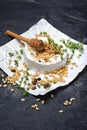 Gourmet appetizer of white brie cheese or camembert with thyme, nuts and honey dipper Royalty Free Stock Photo