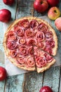 Gourmet apple tart. Open pie with red apple roses and cream fill Royalty Free Stock Photo