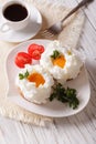 Gourmet breakfast: eggs Orsini and coffee close-up. Vertical