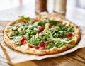 Gourmet brick oven fired chicken and pesto pizza in restaurant