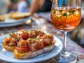 Gourmet Bruschetta with Fresh Tomato and Basil on Artisan Bread Beside a Chilled Glass of Rose Wine on a Sunny Terrace