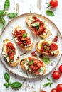 Gourmet Bruschetta With Roasted Tomatoes and Fresh Basil on a White Plate Royalty Free Stock Photo