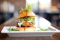 gourmet burger with arugula and goat cheese on a brioche bun