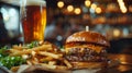 Gourmet burger with cheddar, homemade fries and beer on wooden table Royalty Free Stock Photo