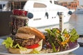 Gourmet burger with salad in a private marina Royalty Free Stock Photo