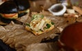 Gourmet canape snack with mushrooms, nuts and micro greens served on parchment paper for wine party