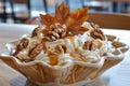 Gourmet Caramel Drizzled Pecan Nut Ice Cream Dessert in Elegant Glass Bowl with Autumn Leaf Garnish Royalty Free Stock Photo