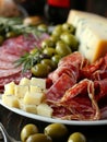 Gourmet charcuterie plate with assorted cheeses, meats, olives, and crackers - perfect for elegant gatherings.