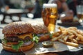 Gourmet cheeseburgers with lagers and seasoned fries in a sunny outdoor setting