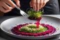 Gourmet Chef Plating an Intricate Dish: Arranging a Delicate Microgreen Salad Atop a Spiral of Ruby Elegance Royalty Free Stock Photo