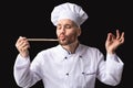 Gourmet Chef Tasting Dish Approving Taste Posing Over Black Background