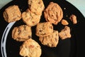 Gourmet cookies on a black plate close up. On green wood. Royalty Free Stock Photo